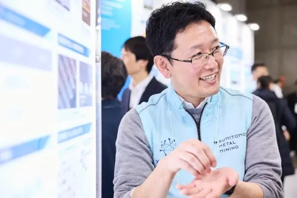 Sumitomo Metal Mining staff explaining the exhibit to visitors