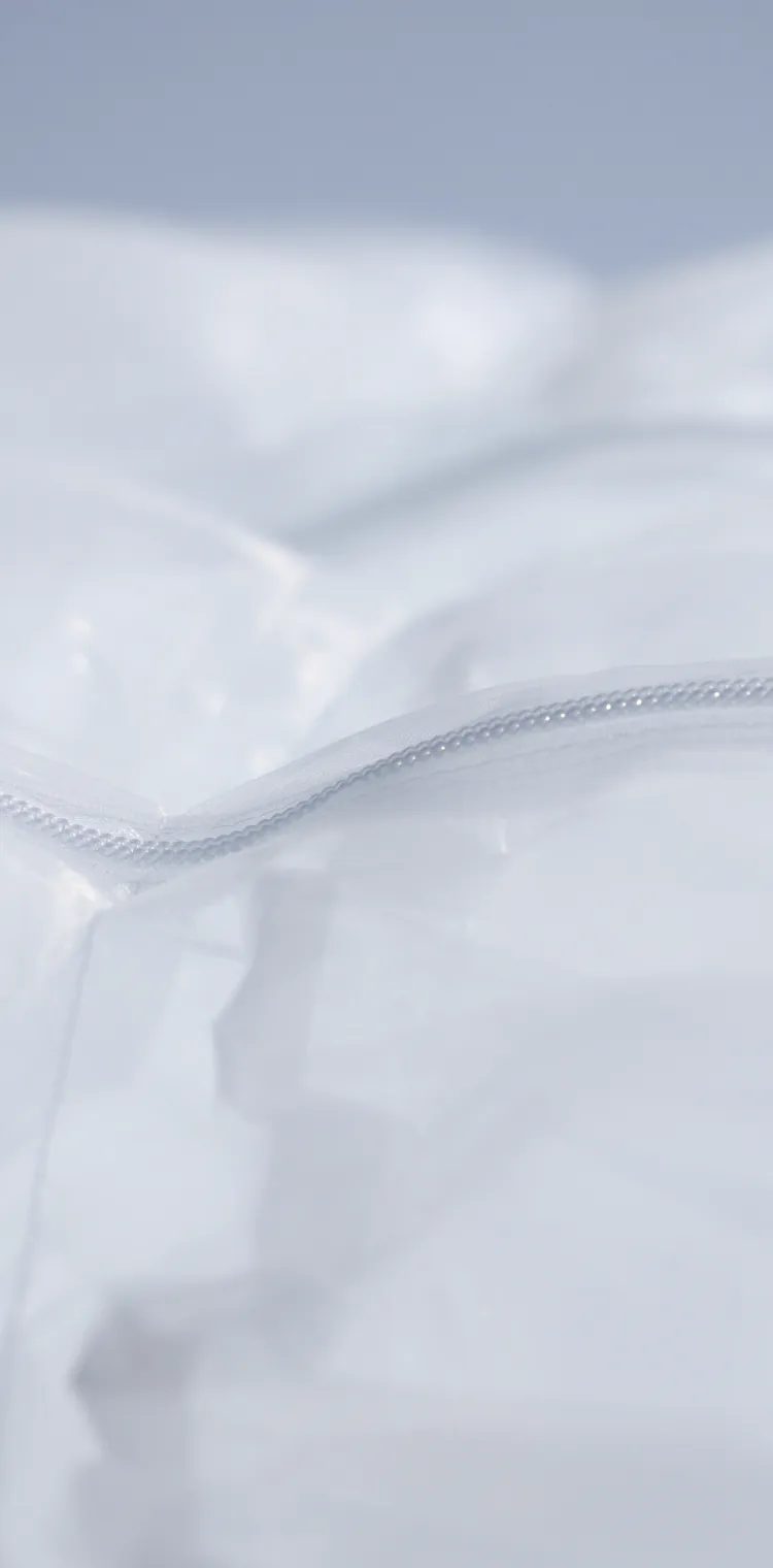 Close-up of SOLAMENT™ material that unlocks new forms of fashion. Its translucent surface and seamless zipper symbolize heat-blocking functionality and a sleek design.