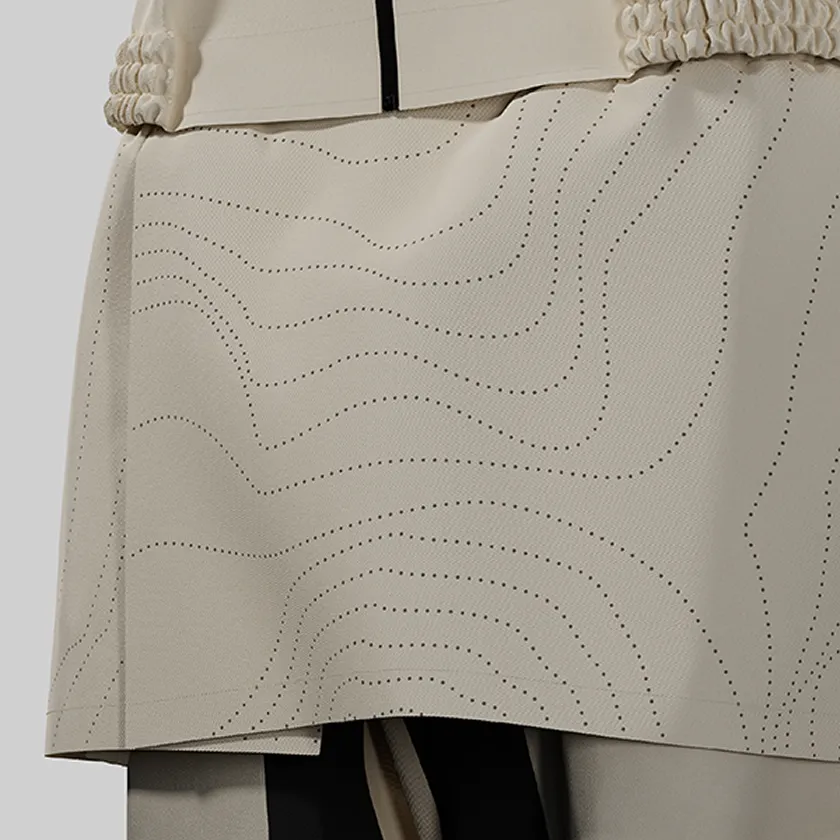 Close-up of the waist of HOPE WEAR for Farm Type B with elastic side shirring and overlapping apron fabric with wavy dotted  lines.