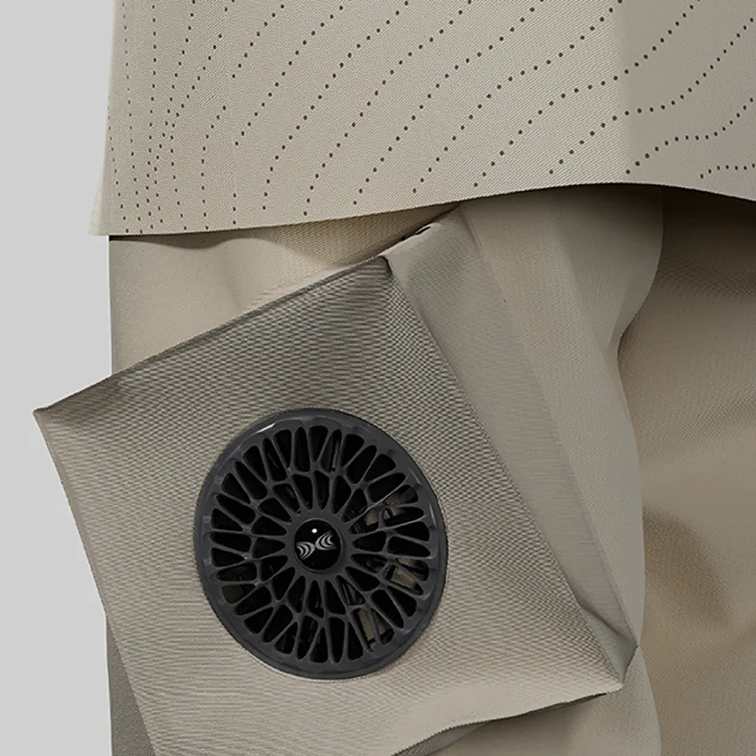 Close-up of the waist of beige HOPE WEAR for Farm Type B with breathable mesh fabric and black cooling fans.