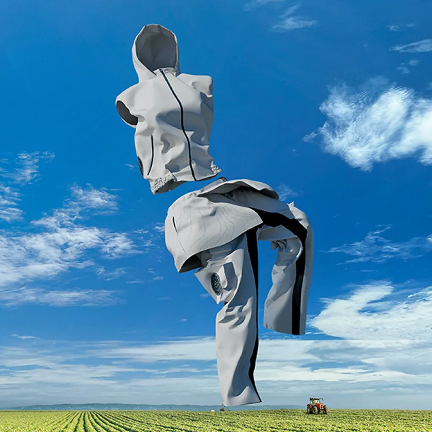 Image visual of a fan-equipped vest and dotted-pattern, fan-equipped pants, HOPE WEAR for Farm Type B, floating against a blue sky.